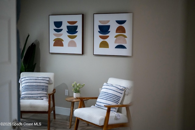 living area featuring wood finished floors and baseboards