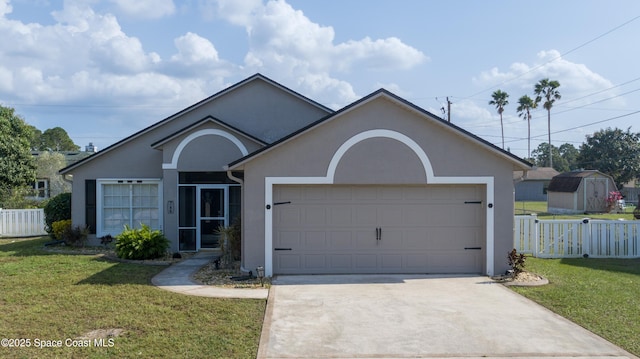 ranch-style house featuring stucco siding, a front yard, an attached garage, and concrete driveway