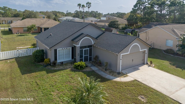 ranch-style house with stucco siding, an attached garage, concrete driveway, and a front lawn