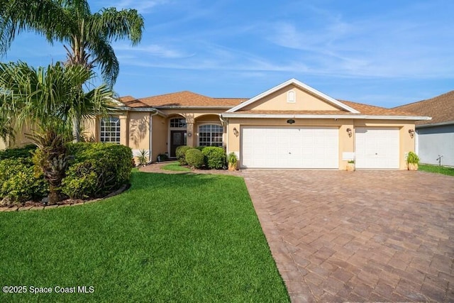 view of front of home with an attached garage, decorative driveway, a front yard, and stucco siding