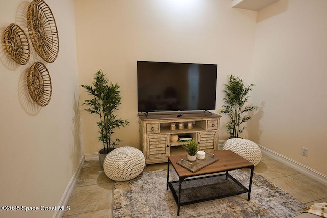 living room with baseboards and light tile patterned floors