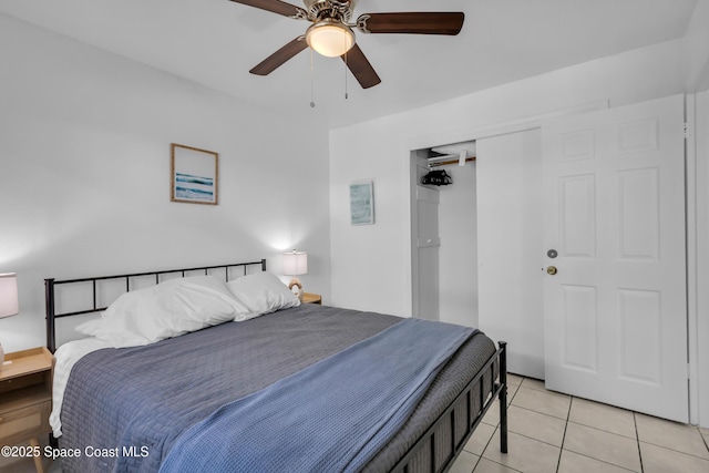 bedroom featuring a ceiling fan, a closet, and light tile patterned floors