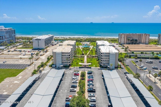 birds eye view of property featuring a water view and a city view