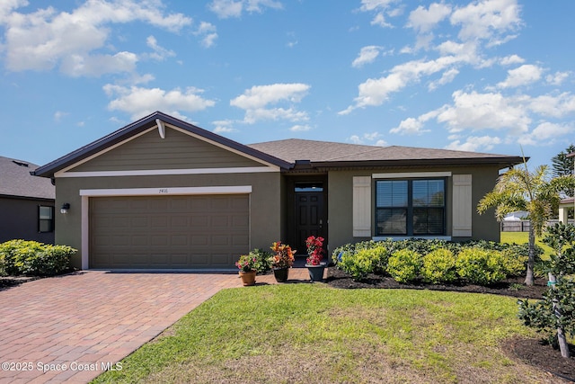 ranch-style house featuring a garage, a front lawn, decorative driveway, and stucco siding