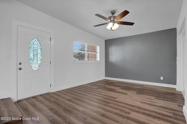 entryway with lofted ceiling, ceiling fan, dark wood-style flooring, and baseboards