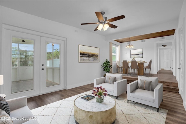 living room with french doors, light wood finished floors, and visible vents