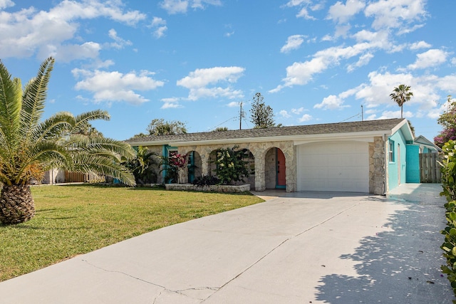 ranch-style house with a garage, driveway, stone siding, and a front yard