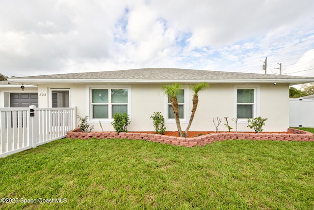 single story home with a front lawn, a shingled roof, fence, and stucco siding