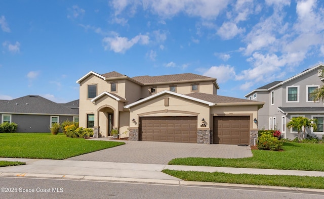 view of front of property featuring decorative driveway, stone siding, an attached garage, and a front lawn