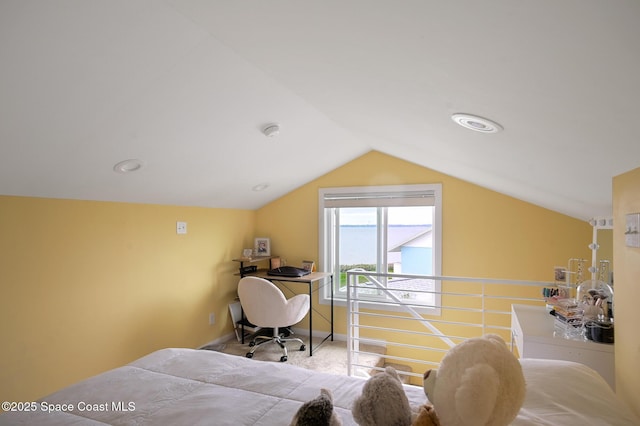 carpeted bedroom featuring lofted ceiling and baseboards