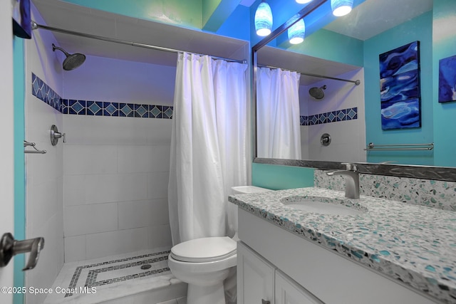 full bath with a stall shower, vanity, and toilet