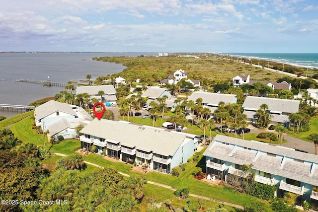 birds eye view of property with a water view and a residential view