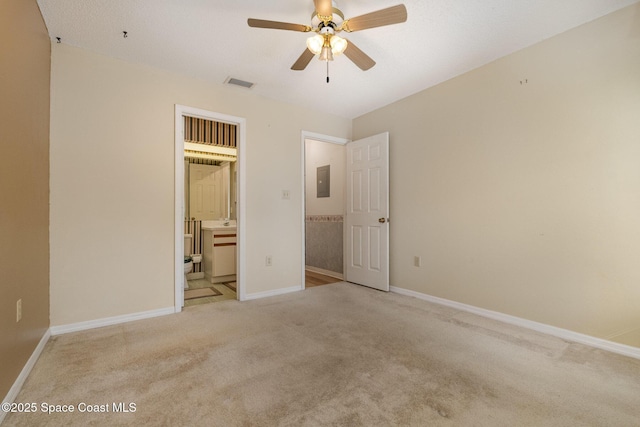 unfurnished bedroom featuring light carpet, baseboards, electric panel, and visible vents