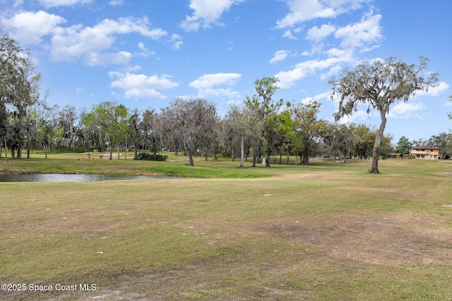 surrounding community featuring a water view and a yard