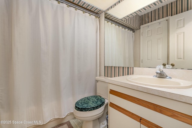 full bath featuring curtained shower, vanity, and toilet