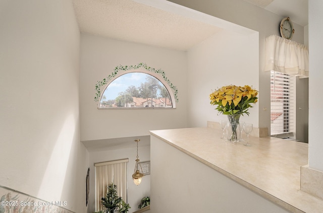 hallway with a textured ceiling