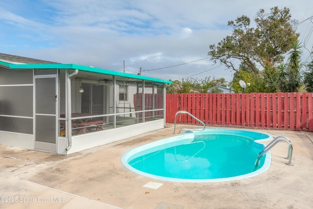 view of pool with a sunroom, a fenced backyard, a fenced in pool, and a patio