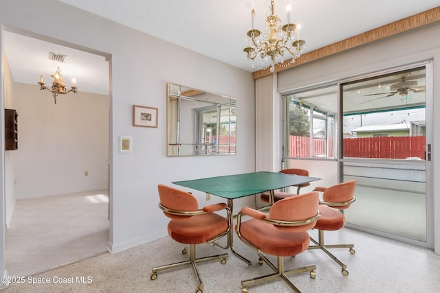 dining area featuring an inviting chandelier, baseboards, visible vents, and speckled floor