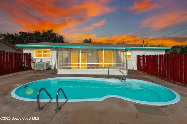 view of pool featuring cooling unit, fence, and a fenced in pool