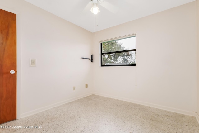 spare room with ceiling fan, baseboards, and speckled floor