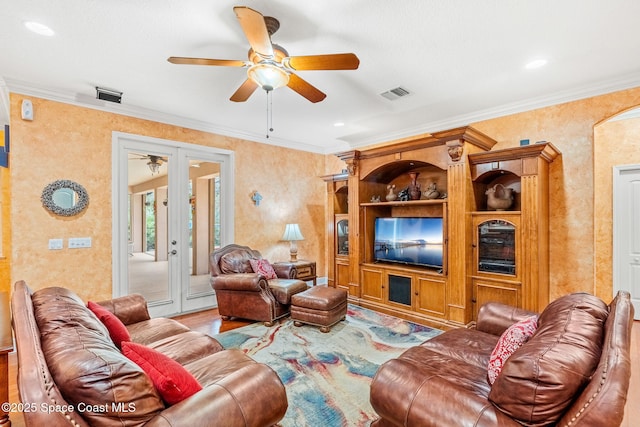 living area with french doors, visible vents, and crown molding