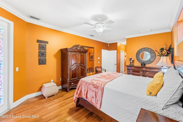 bedroom with ornamental molding, baseboards, visible vents, and light wood finished floors