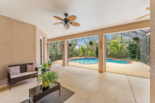 interior space featuring a swimming pool, a ceiling fan, and a wealth of natural light