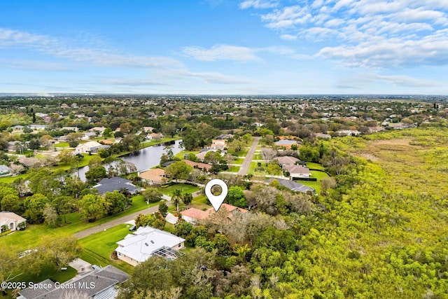 drone / aerial view with a water view and a residential view