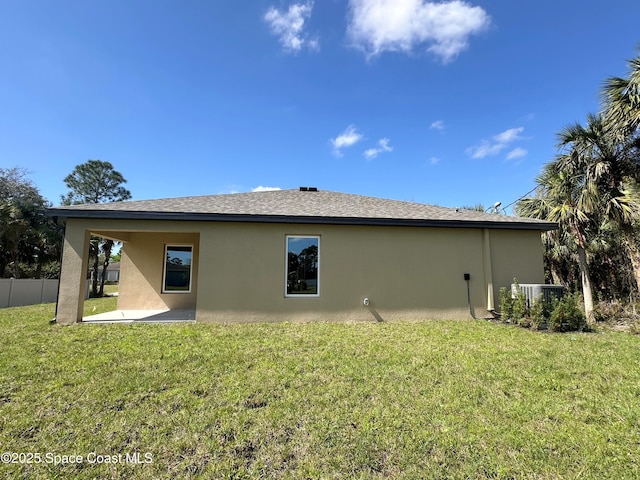 back of property with a patio, fence, a lawn, and stucco siding