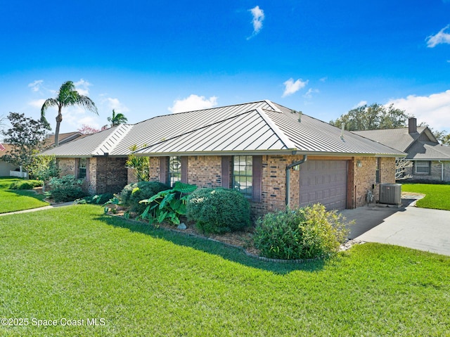 ranch-style house with driveway, metal roof, a standing seam roof, central AC, and brick siding