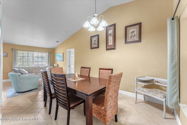 dining space featuring lofted ceiling, baseboards, an inviting chandelier, and light tile patterned floors