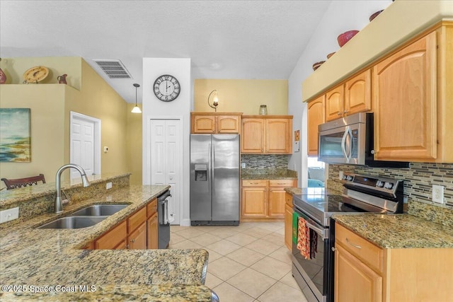 kitchen featuring light tile patterned floors, a sink, visible vents, appliances with stainless steel finishes, and pendant lighting