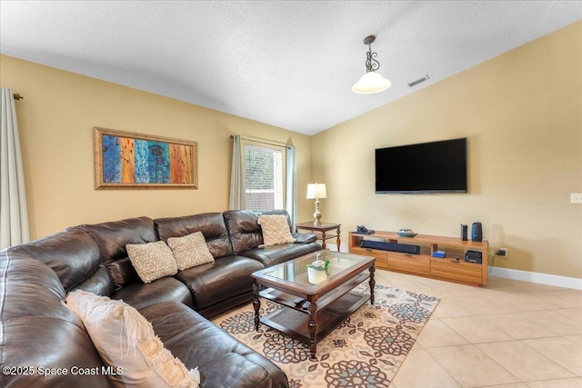 living area featuring light tile patterned floors, baseboards, visible vents, vaulted ceiling, and a textured ceiling