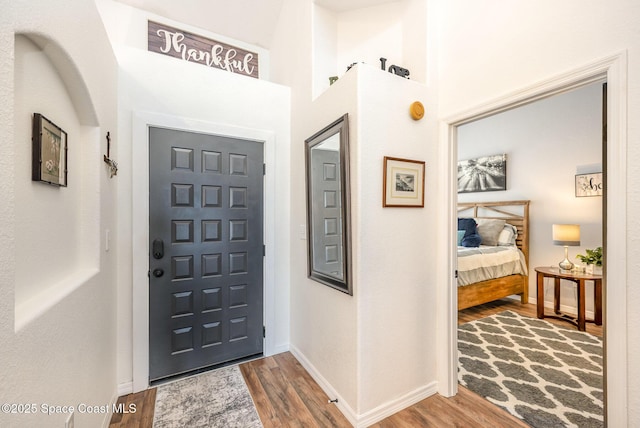 entrance foyer featuring baseboards and wood finished floors