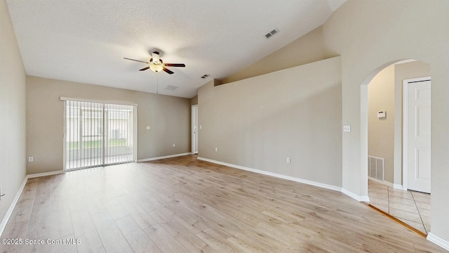 1749 Christina Lee Ln, Saint Cloud, FL 34769 - empty room with visible vents, arched walkways, a ceiling fan, a textured ceiling, and light wood-type flooring