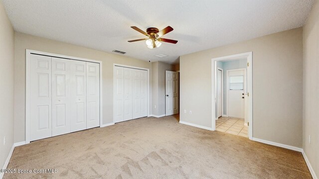 1749 Christina Lee Ln, Saint Cloud, FL 34769 - unfurnished bedroom featuring baseboards, visible vents, multiple closets, and light colored carpet