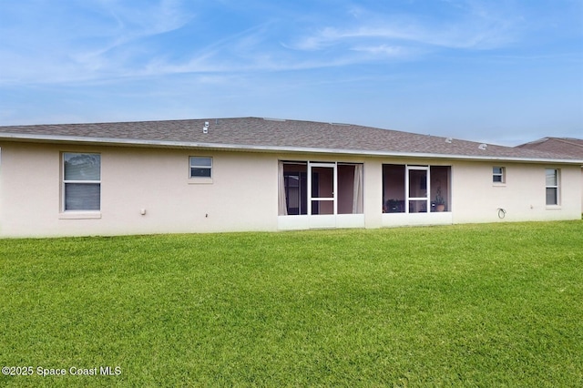 1749 Christina Lee Ln, Saint Cloud, FL 34769 - rear view of property featuring a shingled roof, a lawn, and stucco siding