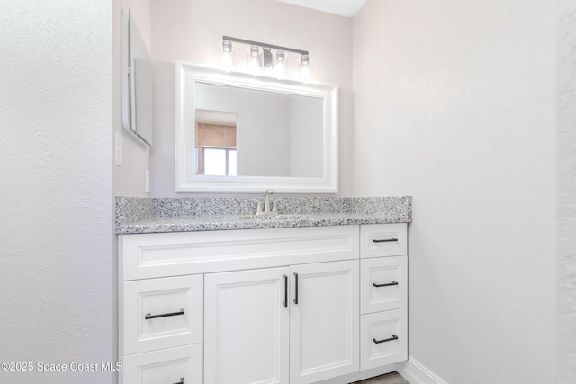 bathroom featuring baseboards and vanity