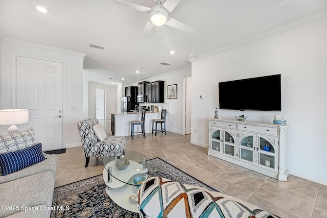 living area with baseboards, ornamental molding, visible vents, and a ceiling fan