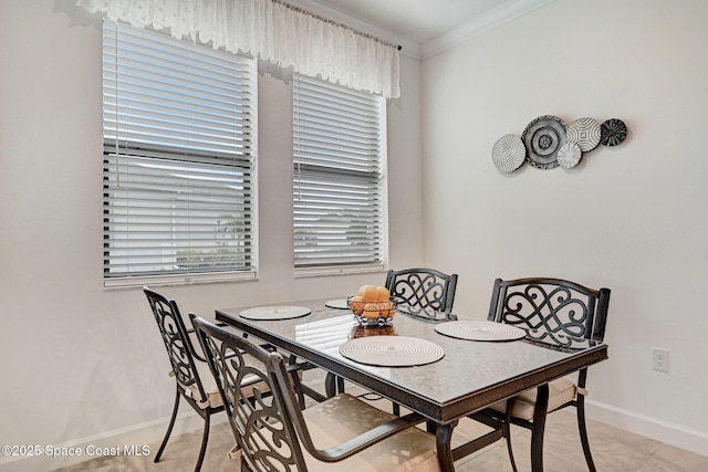 dining area featuring baseboards and crown molding