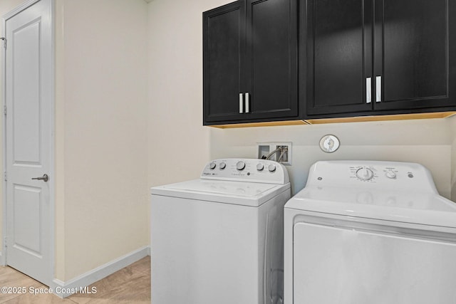 laundry area with cabinet space, baseboards, and separate washer and dryer