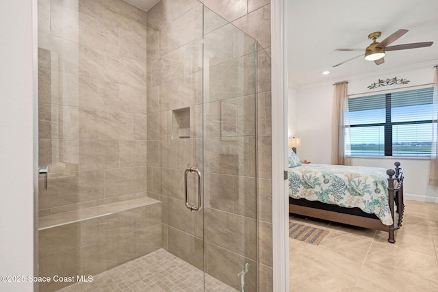 ensuite bathroom featuring ceiling fan, connected bathroom, a shower stall, tile patterned floors, and crown molding