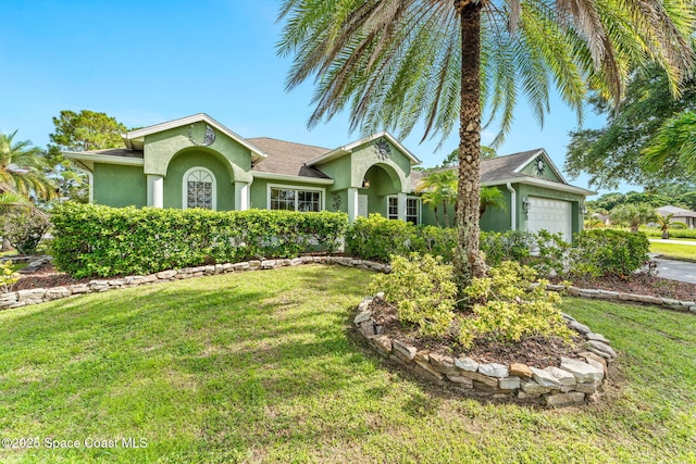 ranch-style house featuring an attached garage, a front yard, and stucco siding