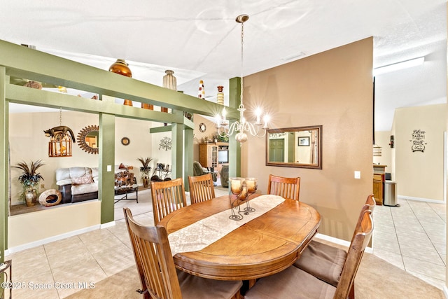 dining area featuring a chandelier, baseboards, and tile patterned floors