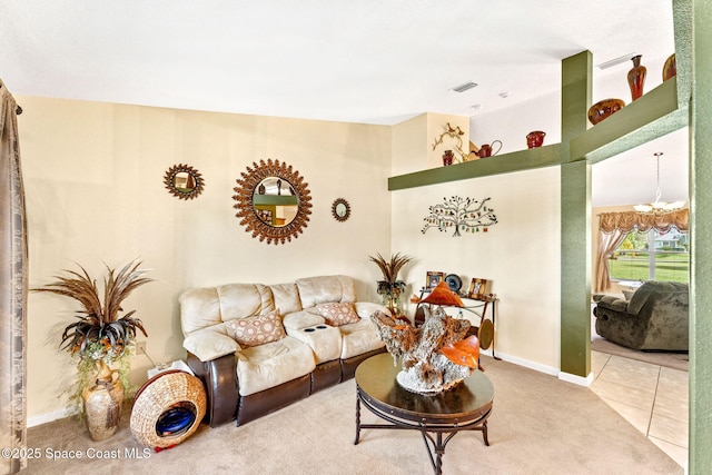 tiled living room with baseboards, visible vents, and a notable chandelier