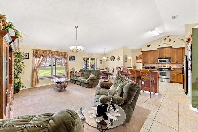 living area with light tile patterned floors, visible vents, light colored carpet, vaulted ceiling, and a chandelier