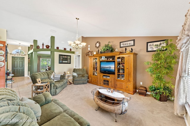 living room featuring vaulted ceiling, a notable chandelier, and light colored carpet