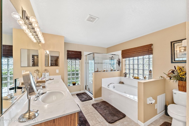 bathroom with visible vents, a sink, a shower stall, and double vanity