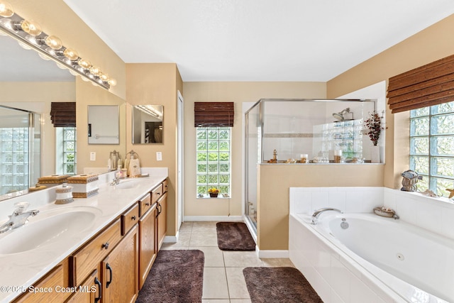 full bathroom with plenty of natural light, tile patterned flooring, a sink, and a tub with jets