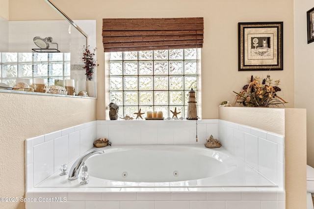 bathroom featuring a tub with jets and walk in shower